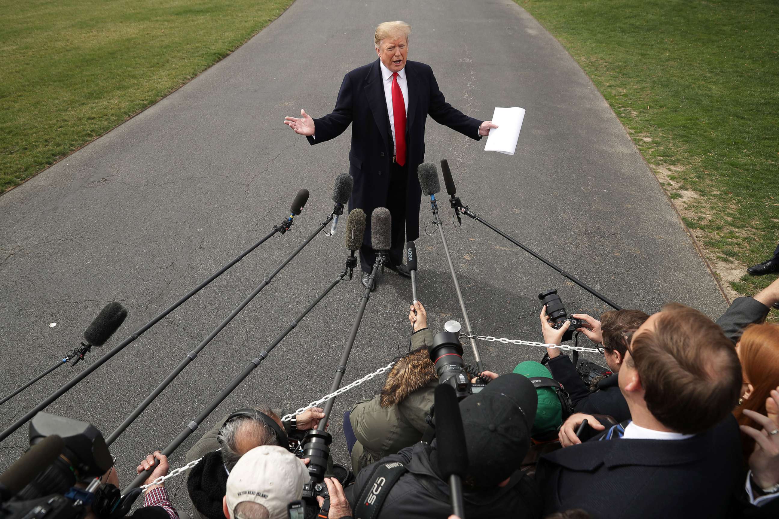 PHOTO: President Donald Trump talks with journalists before departing the White House March 20, 2019.