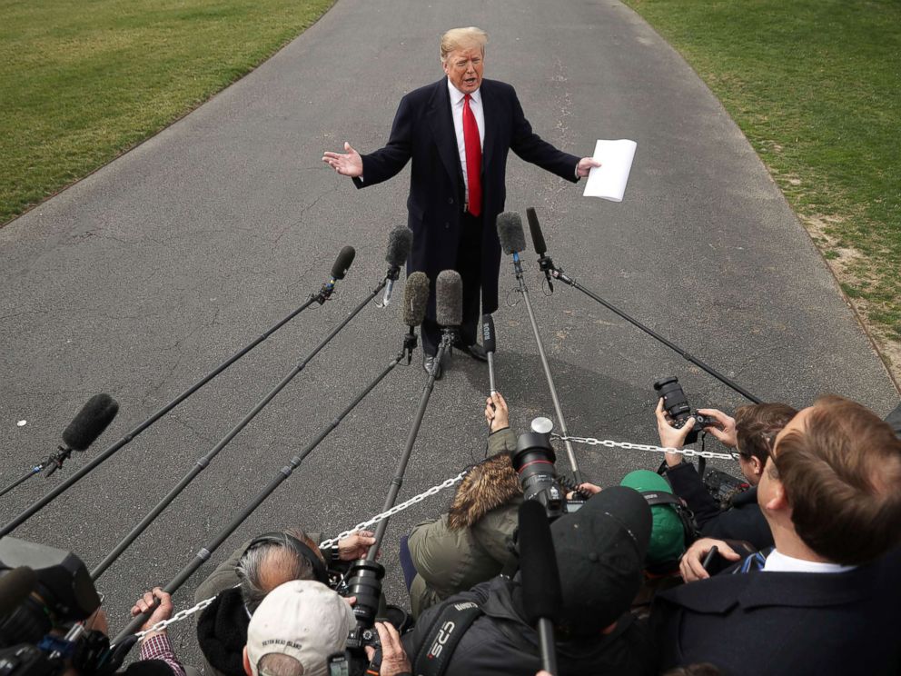 PHOTO: President Donald Trump talks with journalists before departing the White House March 20, 2019.