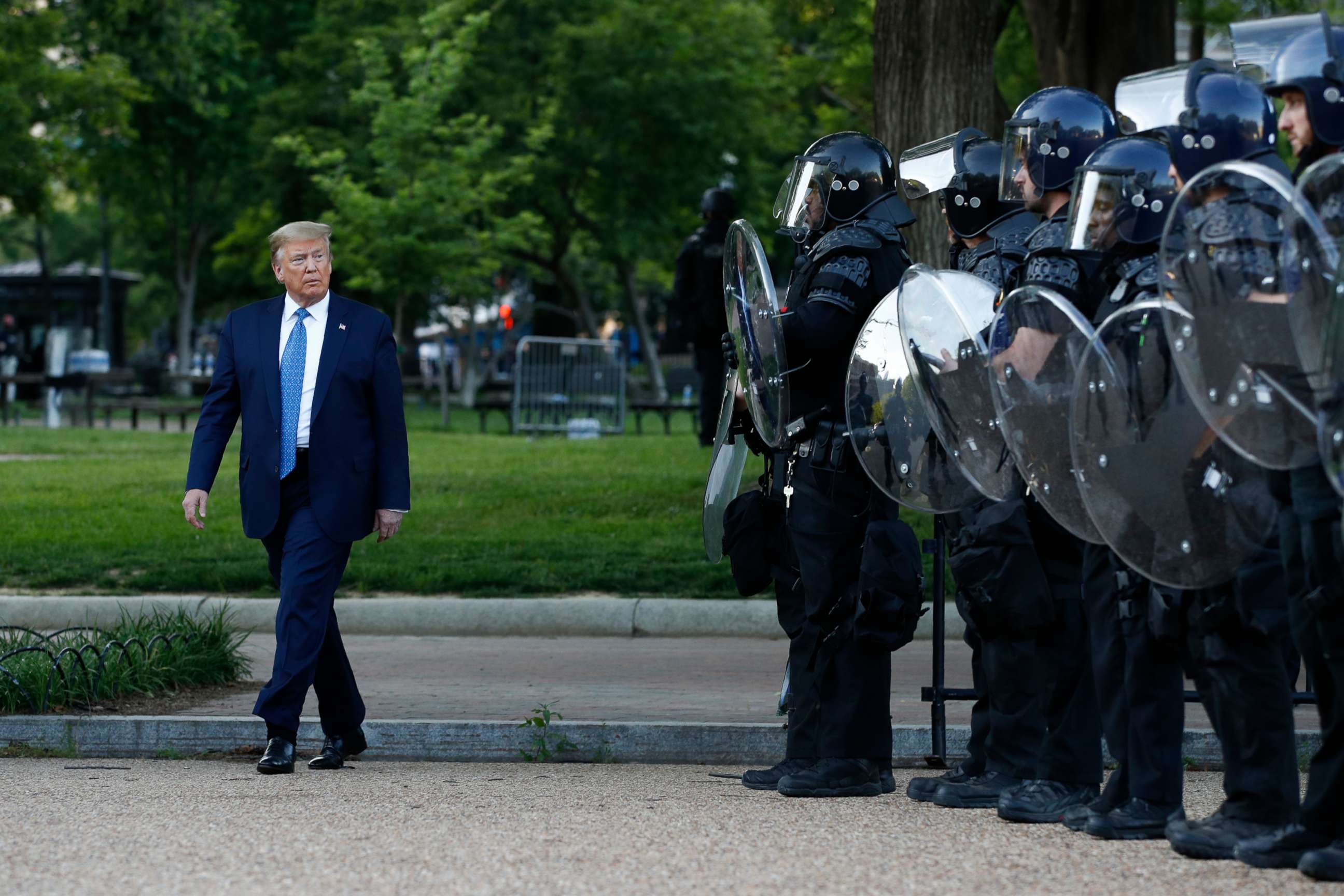 PHOTO: In this Monday, June 1, 2020, file photo President Donald Trump walks past police in Lafayette Park after visiting outside St. John's Church across from the White House in Washington.