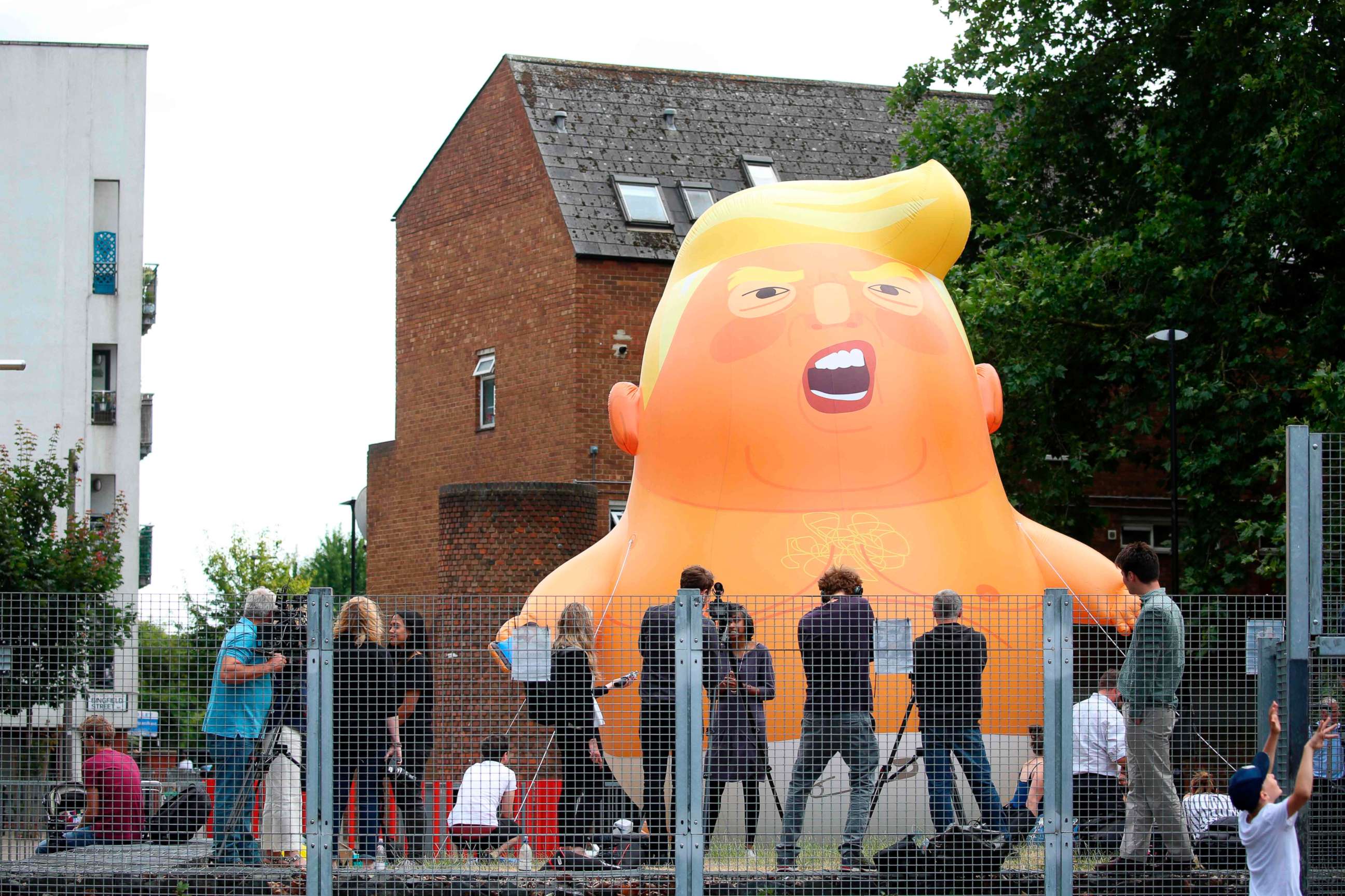 PHOTO: Activists inflate a giant balloon depicting US President Donald Trump as an orange baby in north London on July 10, 2018.