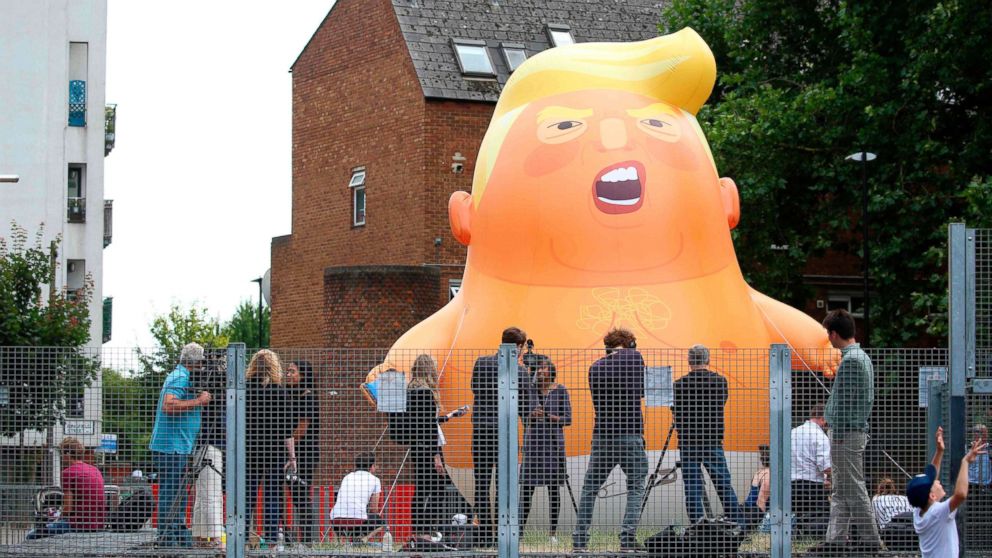 PHOTO: Activists inflate a giant balloon depicting US President Donald Trump as an orange baby in north London on July 10, 2018.