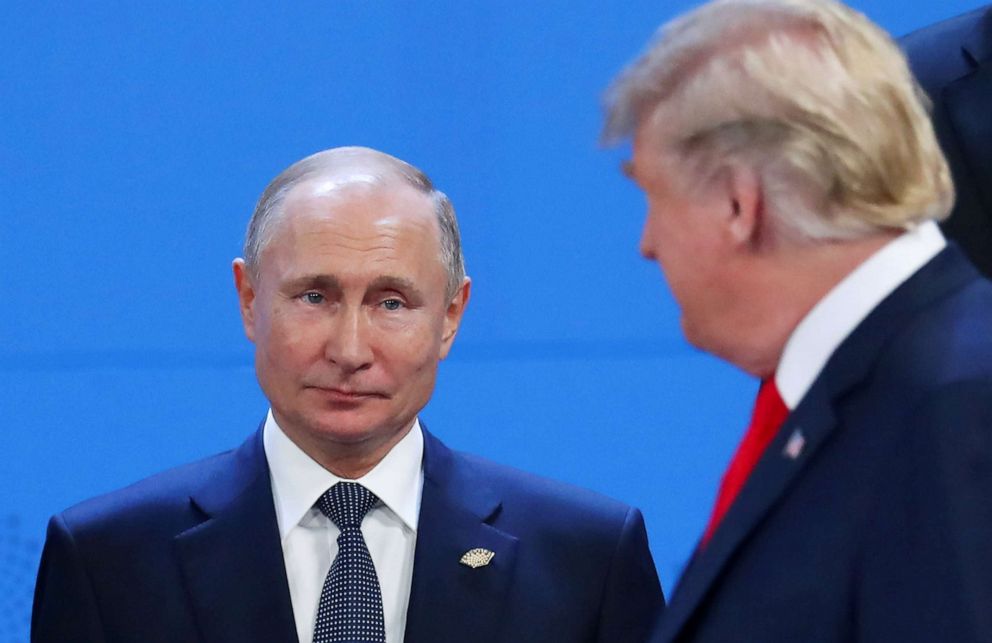 PHOTO: President Donald Trump and Russia's President Vladimir Putin cross paths during the G20 leaders summit in Buenos Aires, Argentina, Nov. 30, 2018. 