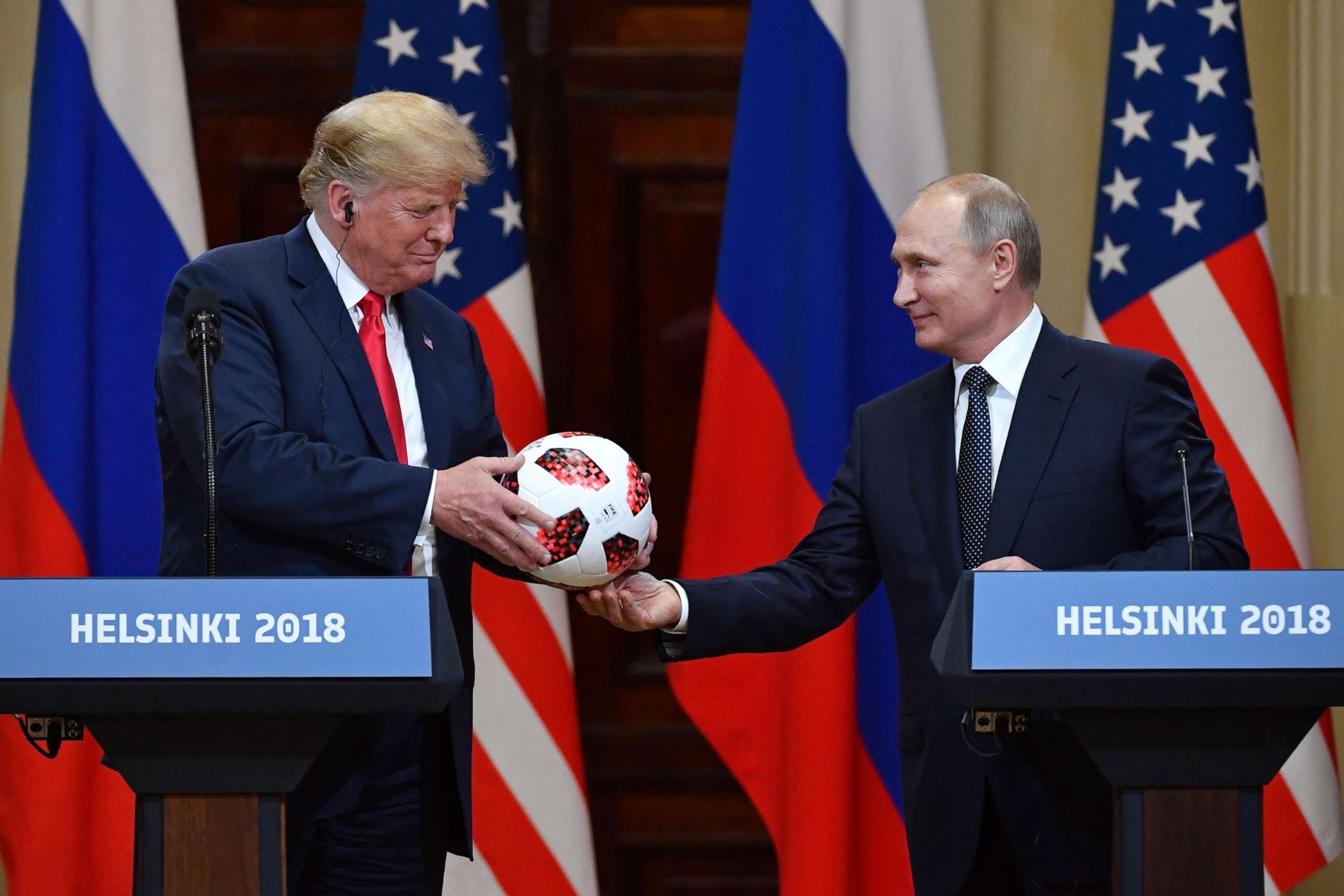 PHOTO: Russia's President Vladimir Putin offers a ball of the 2018 football World Cup to President Donald Trump during a joint press conference after a meeting at the Presidential Palace in Helsinki, Finland, July 16, 2018.
