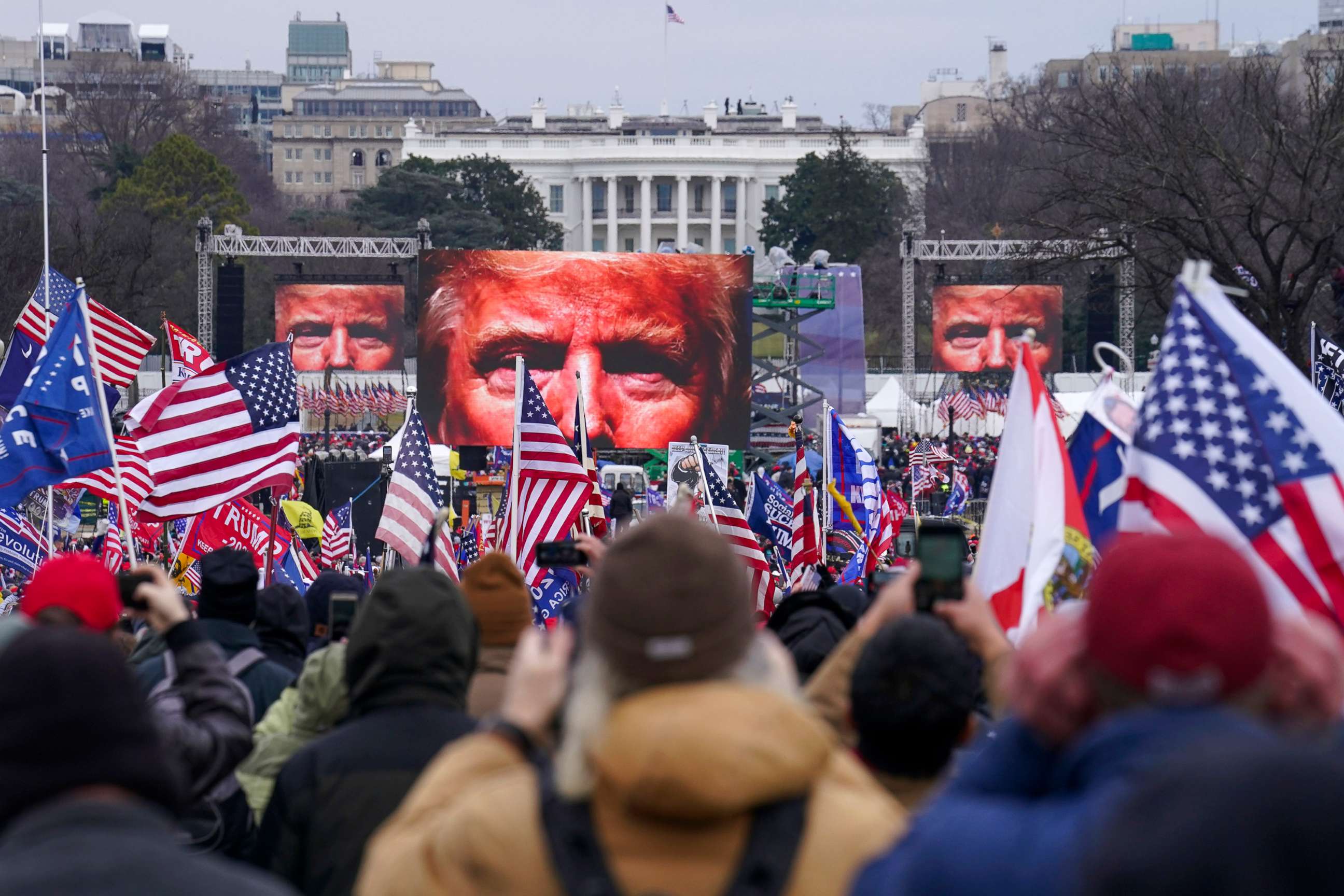 PHOTO: Trump is projected on screens as his supporters rally, Jan. 6, 2021, at the Ellipse in Washington, D.C., near the White House.