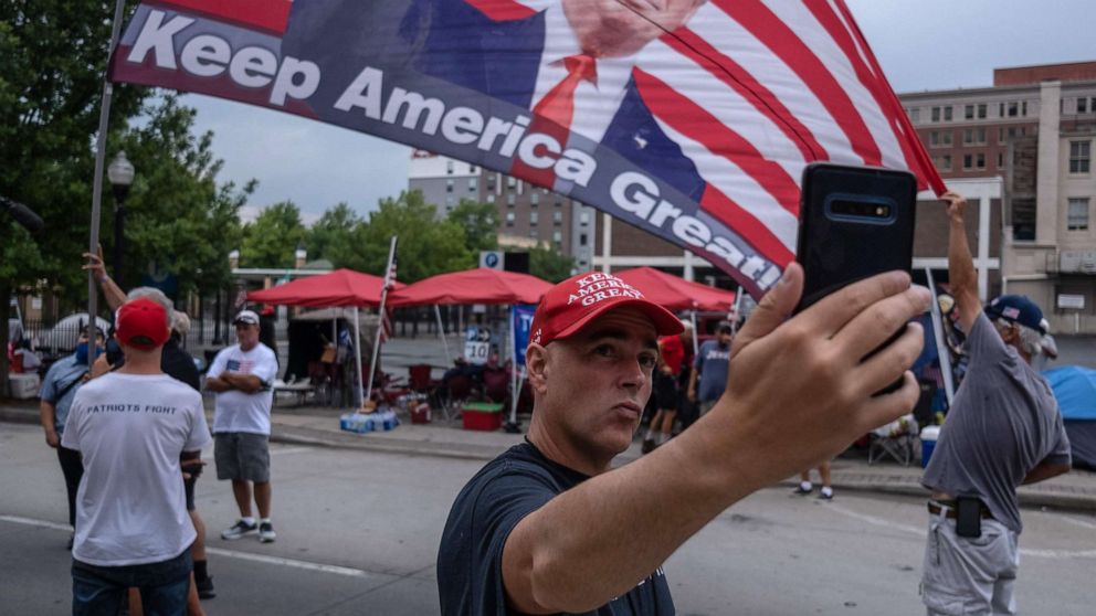 PHOTO: A supporter of US President Donald Trump takes a selfie near the BOK Center on June 19, 2020, in Tulsa, Oklahoma.
