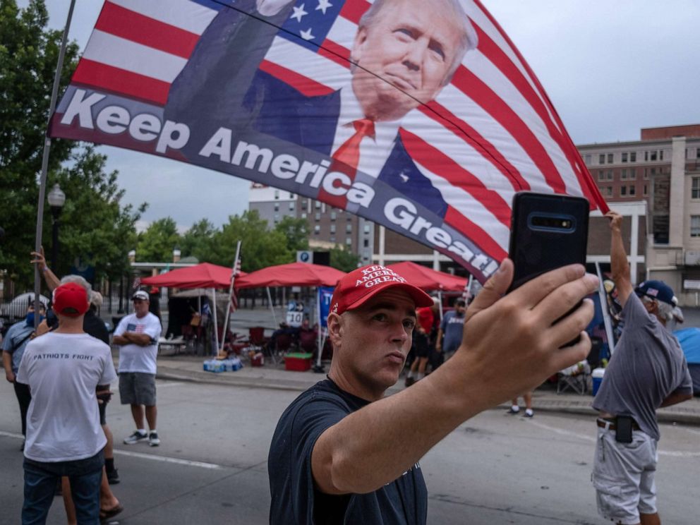 PHOTO: A supporter of US President Donald Trump takes a selfie near the BOK Center on June 19, 2020, in Tulsa, Oklahoma.