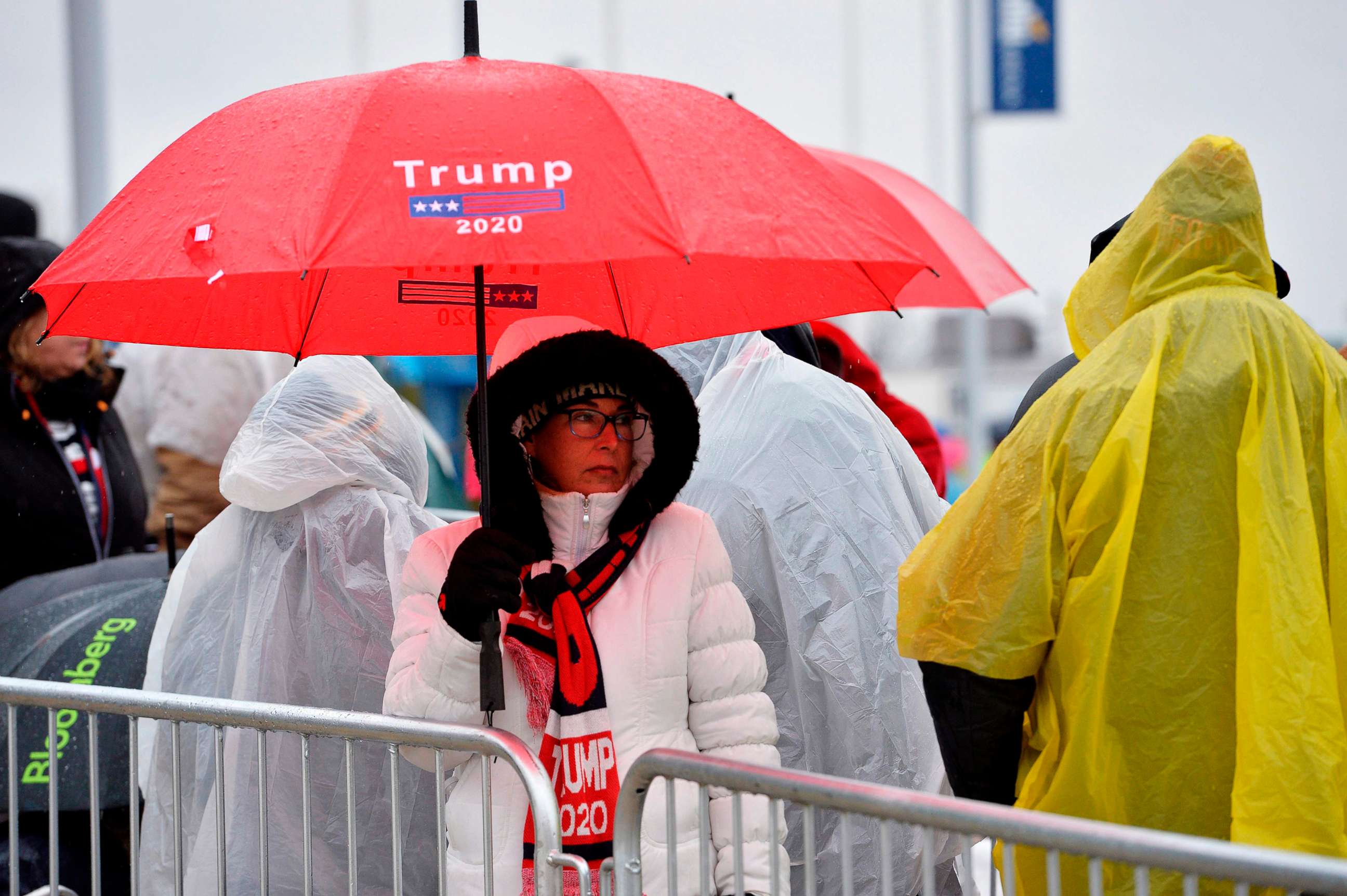 PHOTO: People line up in the rain and icy weather outside the SNHU arena hours ahead of President Donald Trump's rally in Manchester, N.H., Feb. 10, 2020.