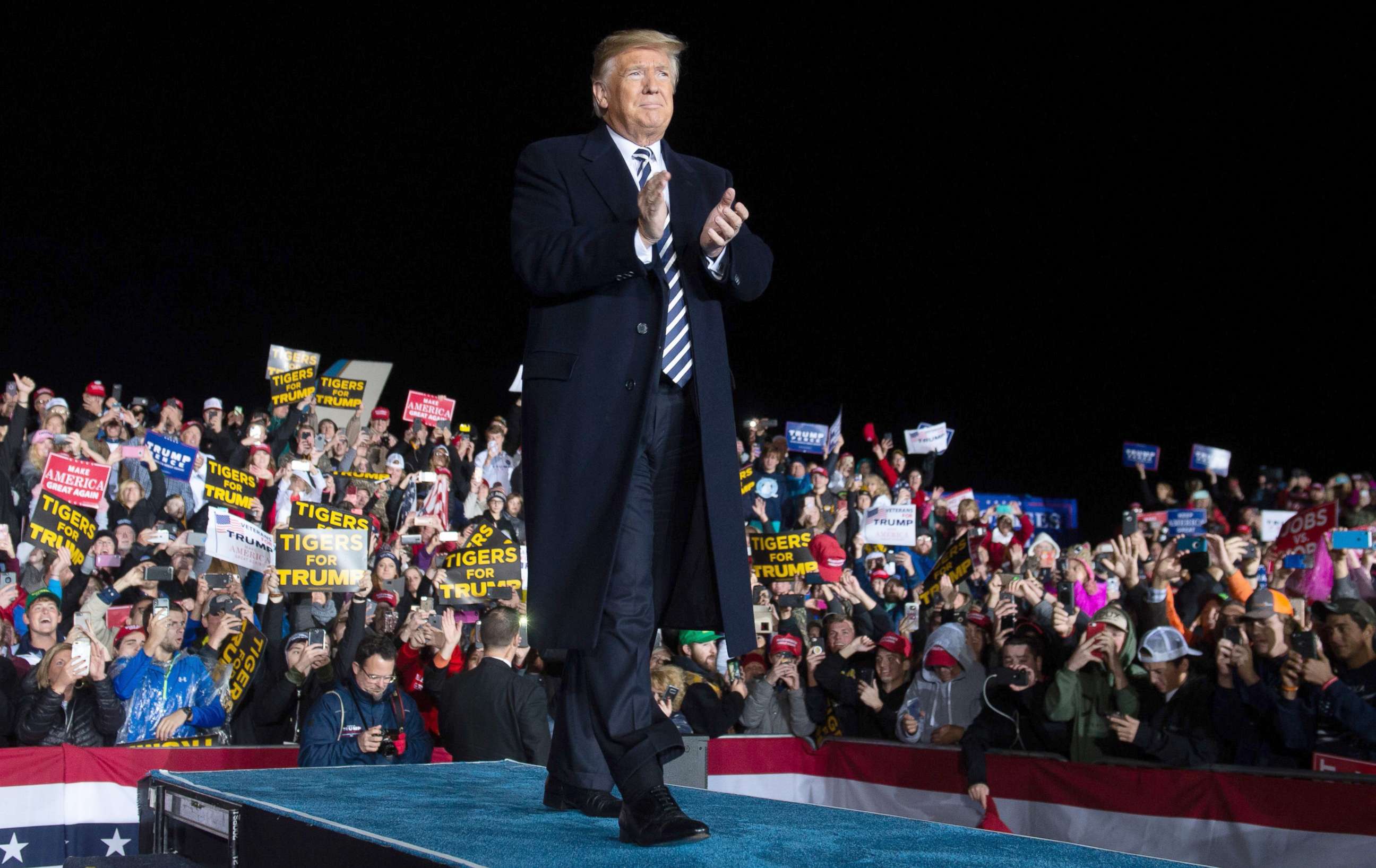 PHOTO: President Donald Trump claps as he arrives to speak at a campaign rally at Columbia Regional Airport in Columbia, Missouri, Nov. 1, 2018.