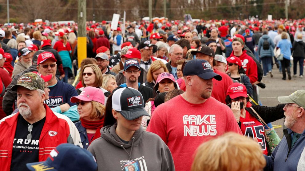 PHOTO: A supporter of President Donald Trump waits in line with a shirt that says "Fake News" to attend a campaign rally in Charlotte, North Carolina, March 2, 2020.