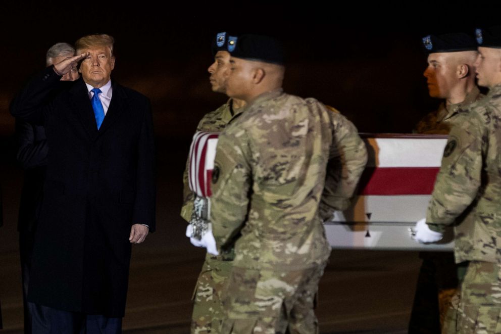 PHOTO: President Donald Trump salutes as a U.S. Army carry team moves a transfer case containing the remains of Kirk Fuchigami Jr., who died in Afghanistan, during a casualty return ceremony, Thursday, Nov. 21, 2019, in Dover Air Force Base, Del.