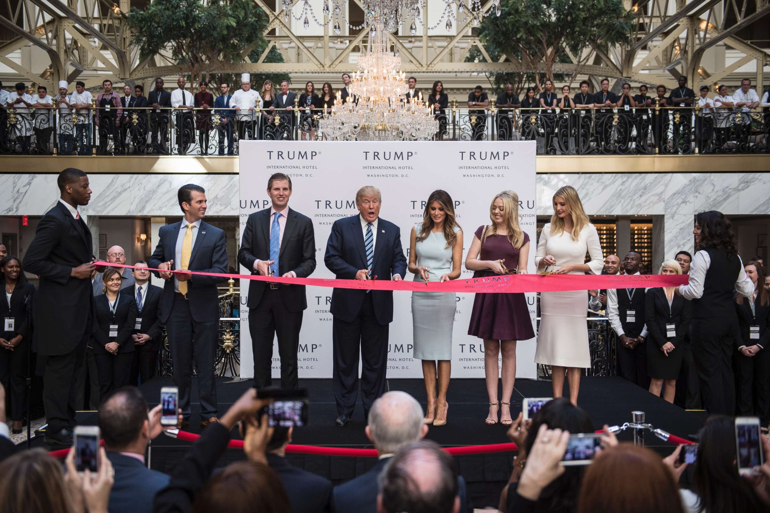 PHOTO: Donald Trump, accompanied by, from left, Donald Trump Jr., Eric Trump, Trump, Tiffany Trump, Melania Trump, and Ivanka Trump, cut a ribbon during the grand opening ceremony of the Trump International Hotel in Washington, D.C., Oct. 26, 2016.