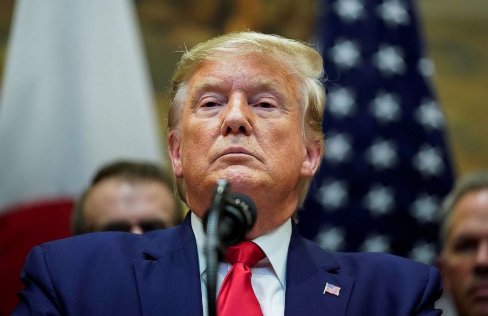 PHOTO: President Donald Trump responds to questions about the House impeachment investigation during a formal signing ceremony for the U.S.-Japan Trade Agreement at the White House in Washington, October 7, 2019.