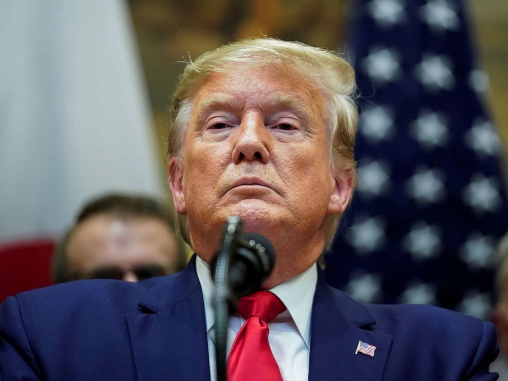 PHOTO: President Donald Trump responds to questions about the House impeachment investigation during a formal signing ceremony for the U.S.-Japan Trade Agreement at the White House in Washington, October 7, 2019.