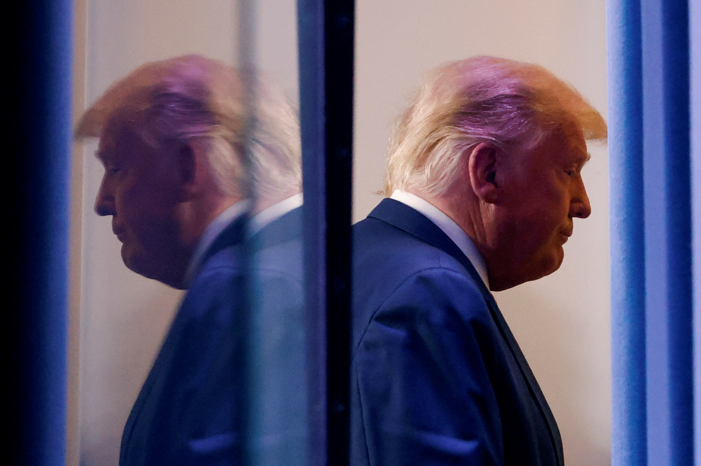 PHOTO: President Donald Trump is reflected as he departs after speaking in the Brady Press Briefing Room at the White House in Washington, Nov. 5, 2020.