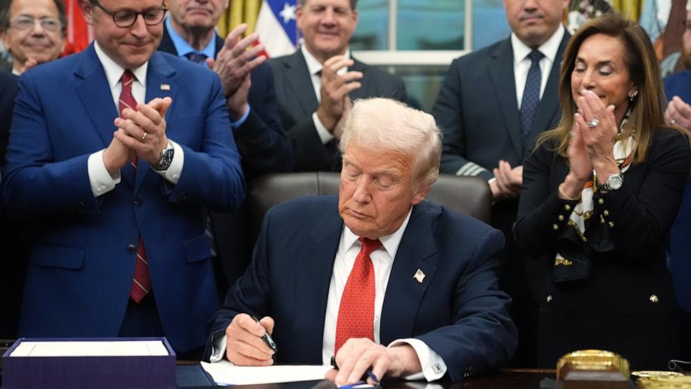 PHOTO: President Donald Trump signs the funding bill to reopen the government in the Oval Office on Wednesday, Nov. 12, 2025.