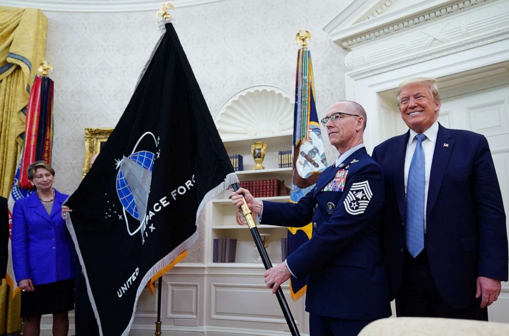 PHOTO: Space Force Senior Enlisted Advisor CMSgt Roger Towberman with President Donald Trump, presents the U.S. Space Force Flag on May 15, 2020, in the Oval Office.