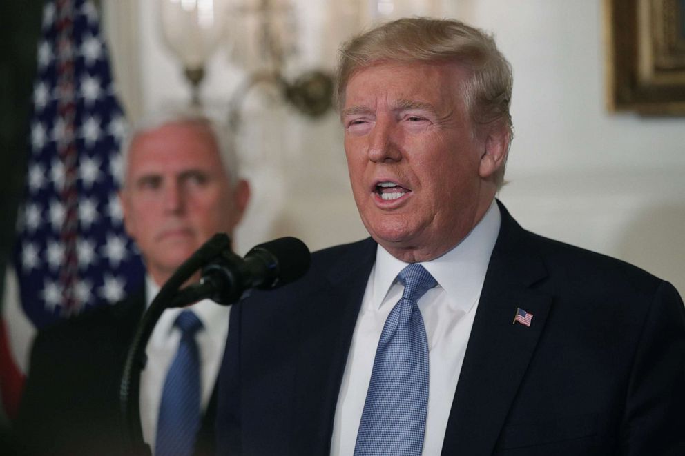 PHOTO: President Donald Trump makes remarks in the Diplomatic Reception Room of the White House as Vice President Mike Pence looks, Aug.5, 2019, following the mass shootings in El Paso, Texas, and Dayton, Ohio.
