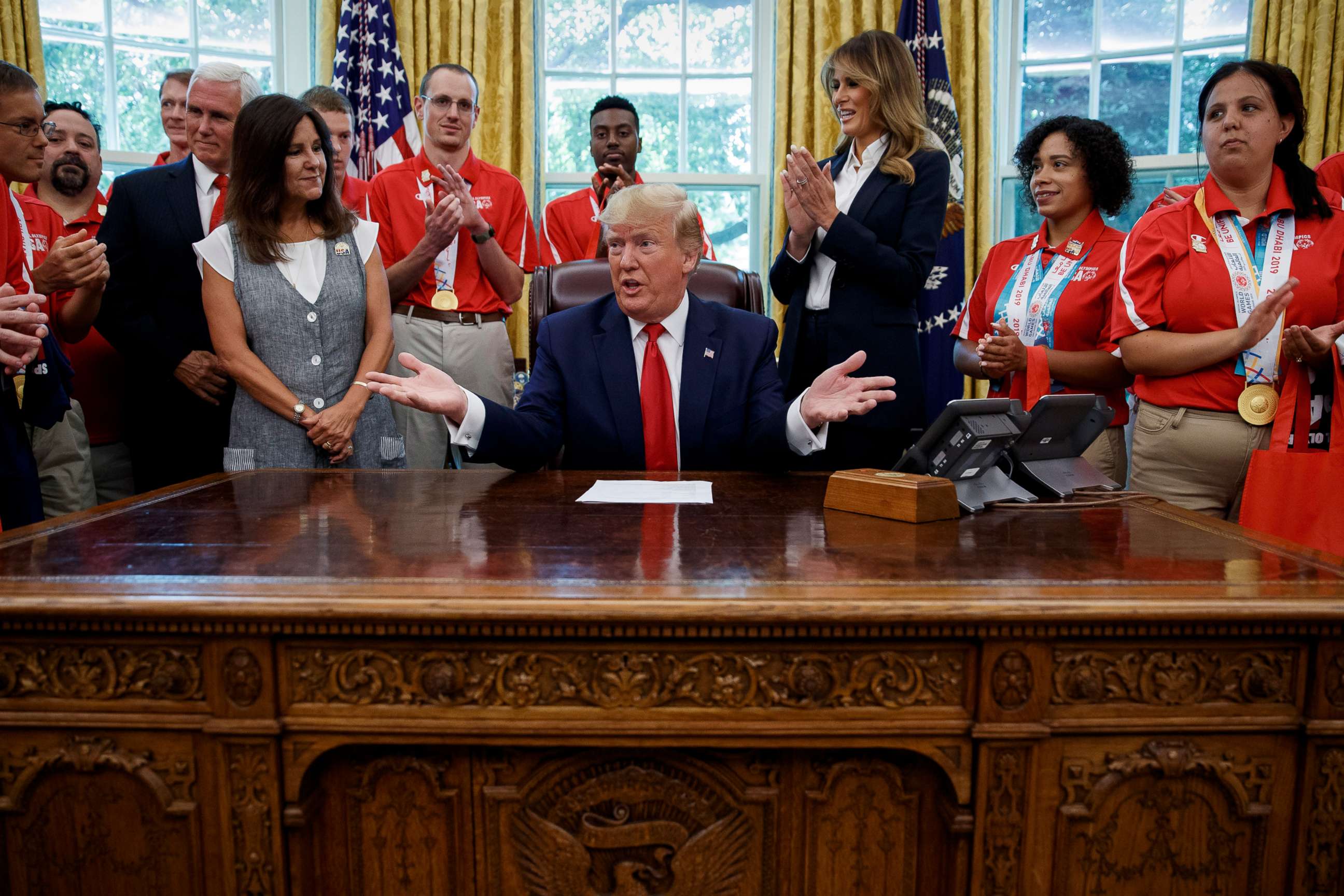 PHOTO: President Donald Trump, accompanied by Vice President Mike Pence, Karen Pence, and first lady Melania Trump, speaks during a photo opportunity with Special Olympics athletes and staff, in the Oval Office, July 18, 2019.