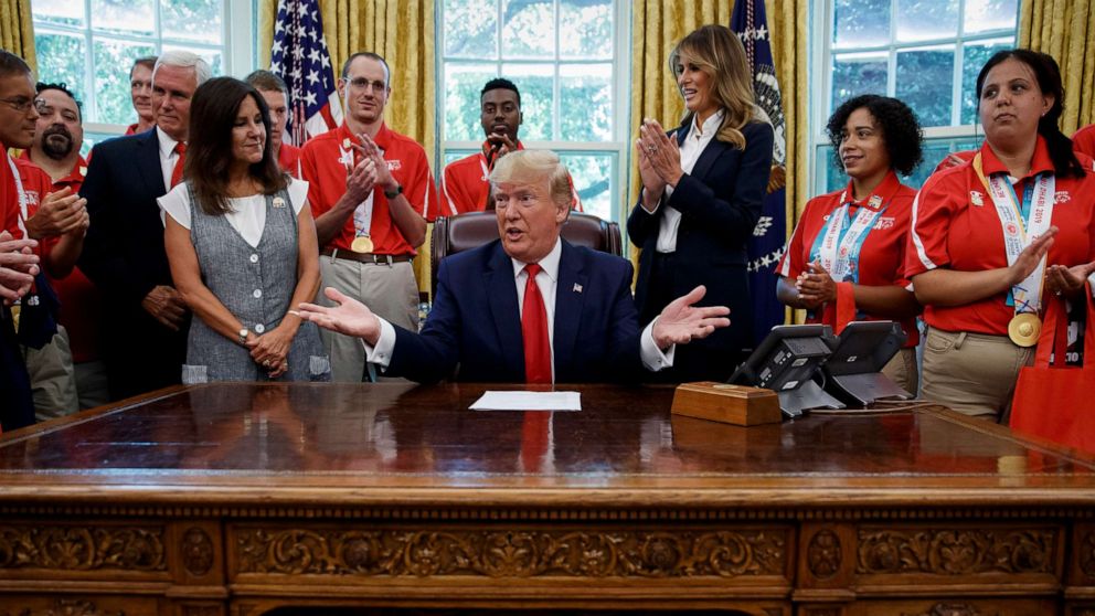PHOTO: President Donald Trump, accompanied by Vice President Mike Pence, Karen Pence, and first lady Melania Trump, speaks during a photo opportunity with Special Olympics athletes and staff, in the Oval Office, July 18, 2019.