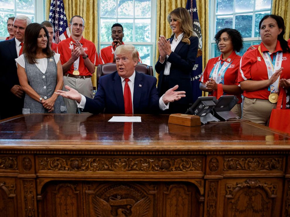 PHOTO: President Donald Trump, accompanied by Vice President Mike Pence, Karen Pence, and first lady Melania Trump, speaks during a photo opportunity with Special Olympics athletes and staff, in the Oval Office, July 18, 2019.
