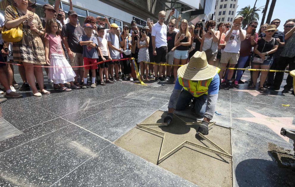 PHOTO: Workers repair the Donald Trump's star on the Hollywood Walk of Fame in Los Angeles on July 25, 2018. Trump's star was destroyed Wednesday morning by a man with a pick ax, the second time in less than two years the star was vandalized.