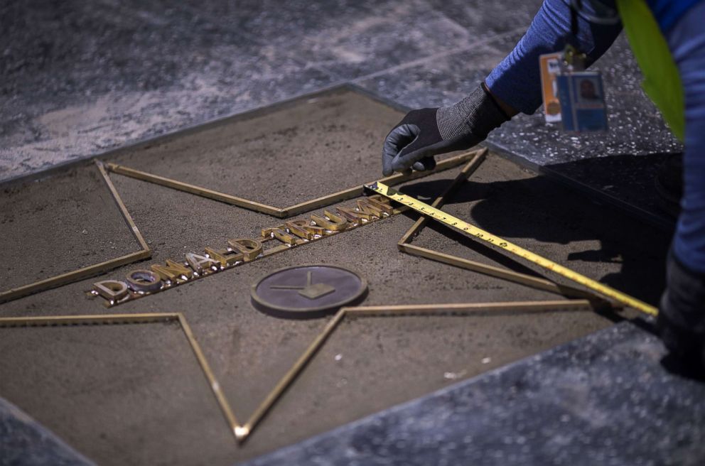 PHOTO: Workers replace the Star of President Donald Trump on the Hollywood Walk of Fame after it was destroyed by a vandal in the early morning hours on July 25, 2018 in Los Angeles, California.