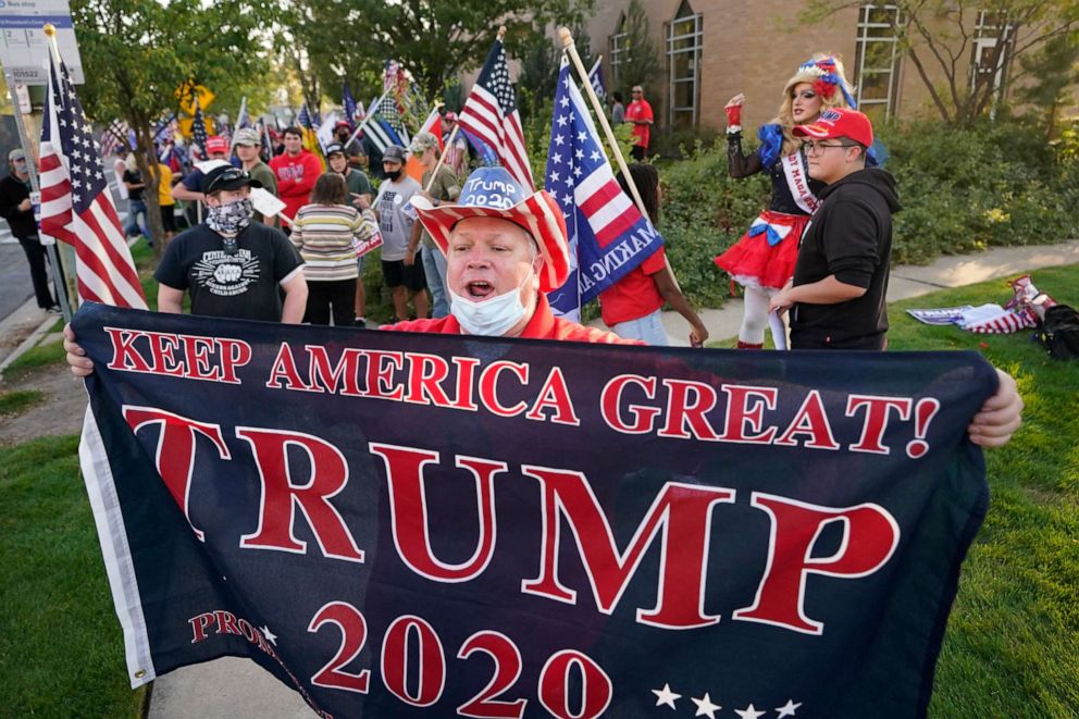 PHOTO: A supporter of President Donald Trump holds a banner before the vice presidential debate between Vice President Mike Pence and Sen. Kamala Harris, at the University of Utah, Oct. 7, 2020, in Salt Lake City.