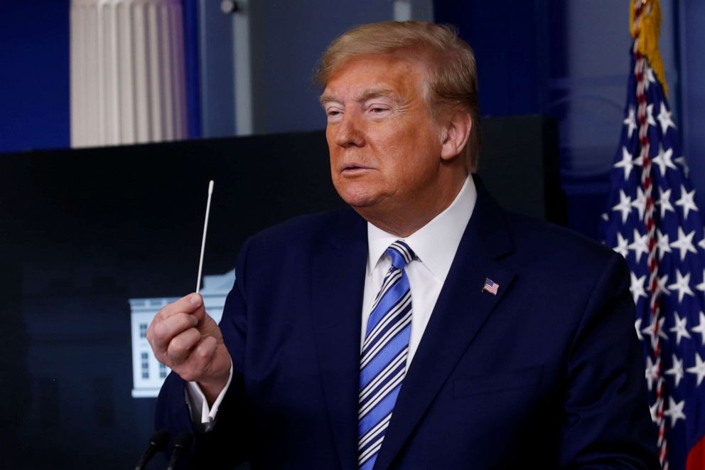 PHOTO: President Donald Trump holds up a swab for coronavirus disease (COVID-19) testing during the daily coronavirus task force briefing at the White House in Washington, April 19, 2020.
