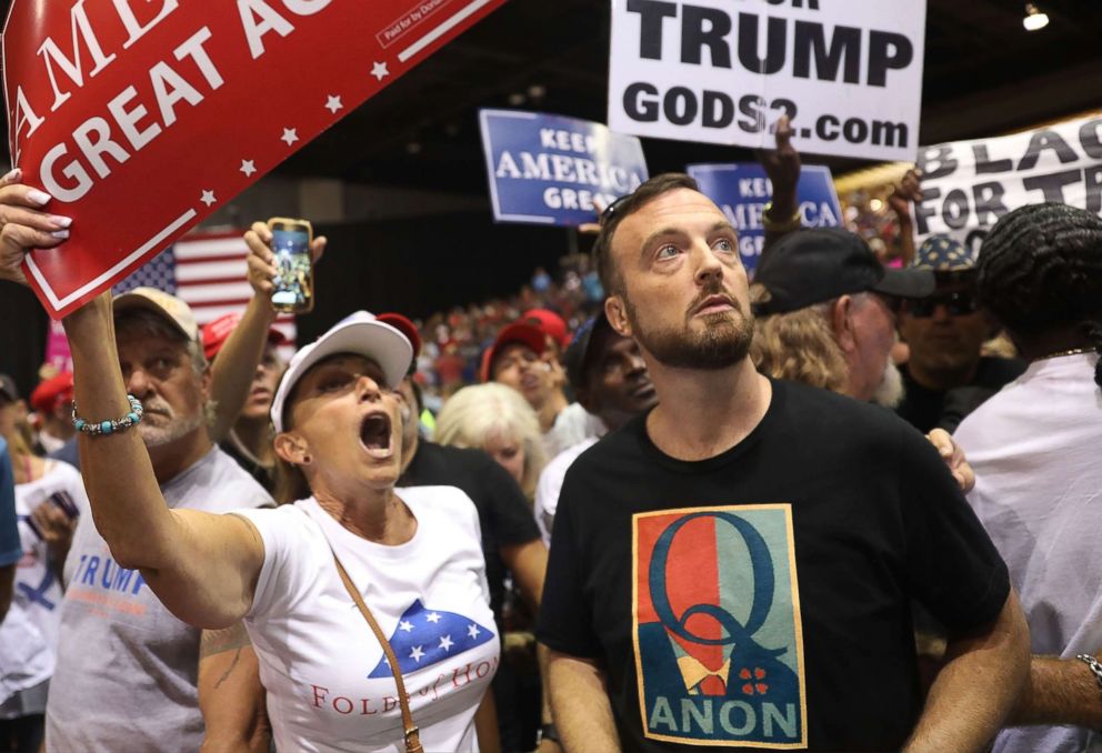 PHOTO: A man wearing a shirt with the words "Q Anon" attends a rally for President Donald Trump on July 31, 2018 in Tampa, Fla.