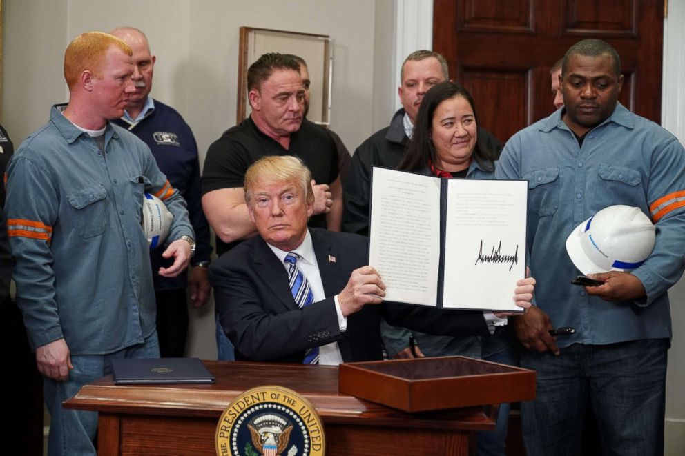 PHOTO: President Donald Trump signs Section 232 Proclamations on Steel and Aluminum Imports in the Oval Office of the White House, March 8, 2018, in Washington.