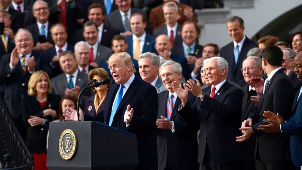  Surrounded by Republican Senators and House Representatives, President Donald Trump speaks about the passage of tax reform legislation on the South Lawn of the White House, December 20, 2017.
