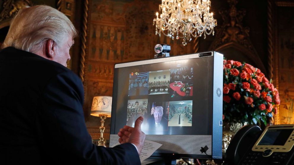 PHOTO: President Donald Trump speaks with members of the armed forces via video conference at his private club, Mar-a-Lago, on Thanksgiving, Nov. 23, 2017, in Palm Beach, Fla.