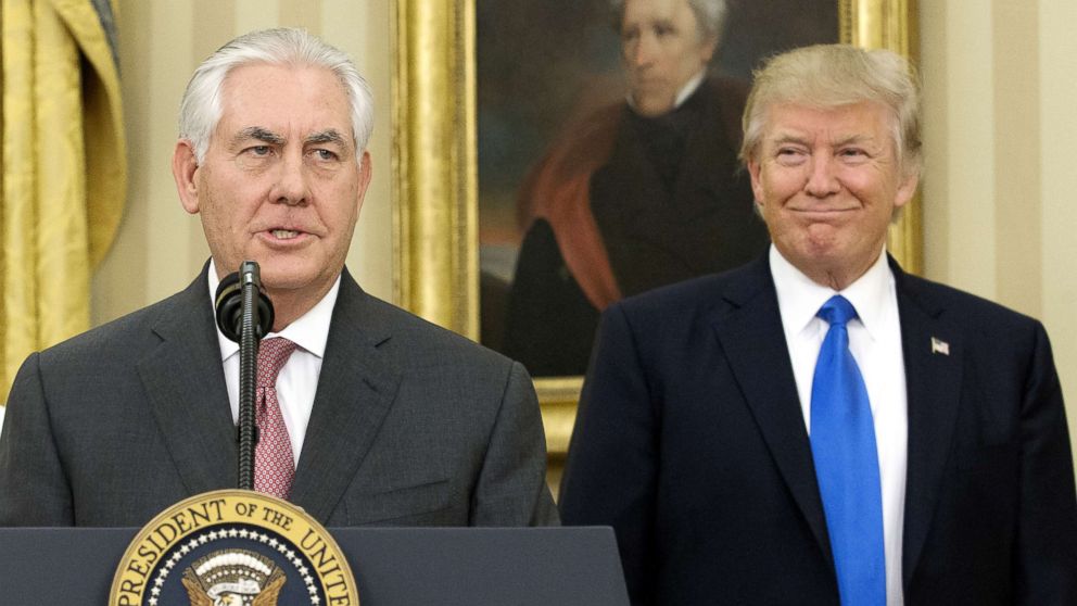 Rex Tillerson speaks as Donald Trump listens in the Oval Office of the White House after his swearing-in ceremony, Feb. 1, 2017.