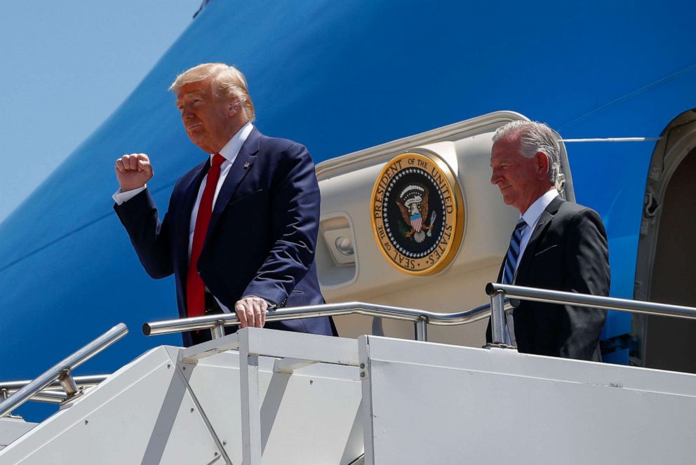 PHOTO: In this June 11, 2020, file photo, President Donald Trump gestures as he steps off Air Force One at Dallas Love Field in Dallas with Senate candidate Tommy Tuberville.
