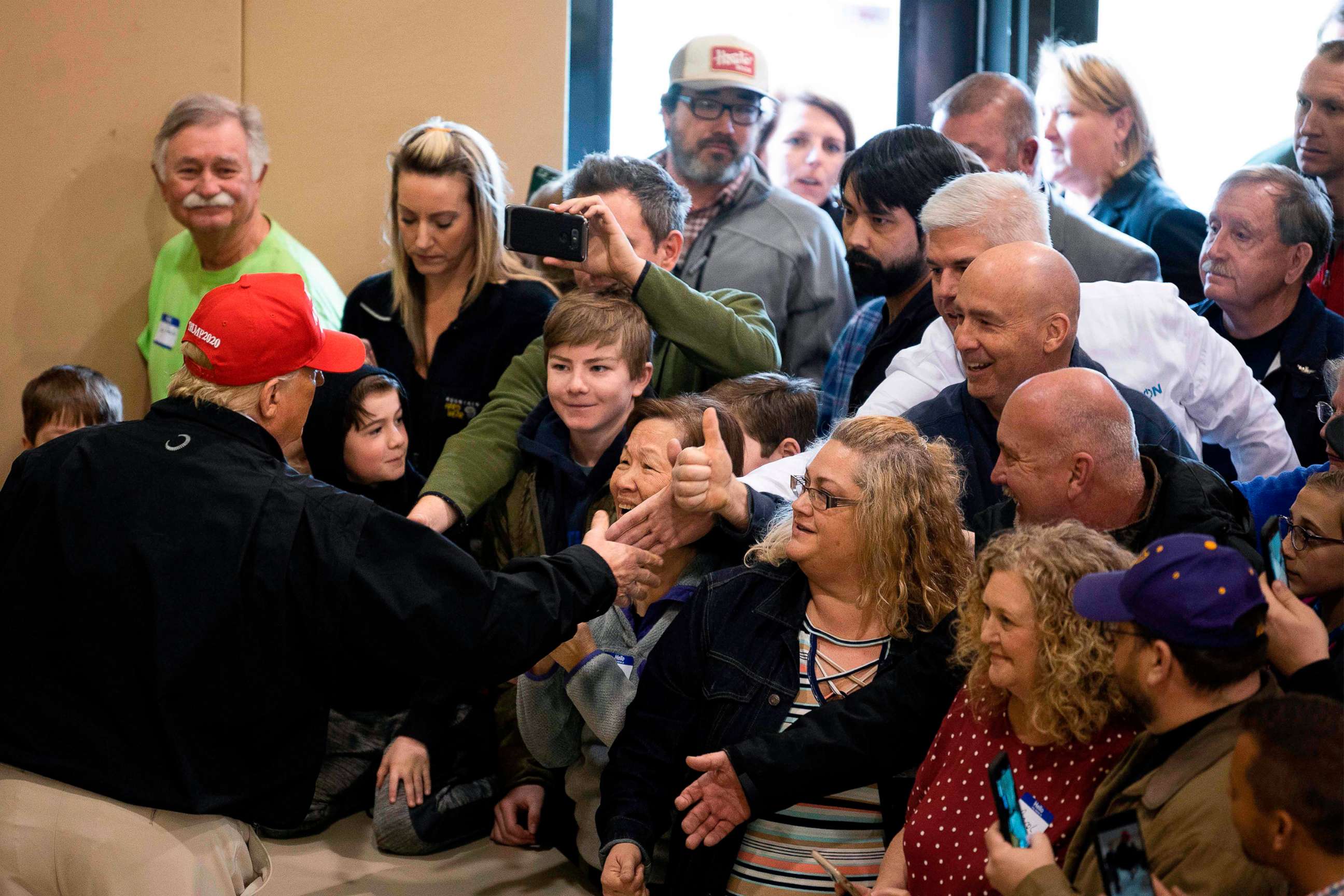 PHOTO: President Donald Trump shakes hands with people at the Jefferson Avenue Church of Christ disaster relief distribution center after touring tornado damage in Cookeville, Tenn., on March 6, 2020