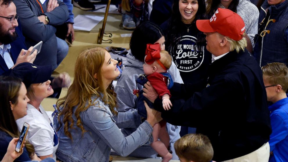 PHOTO: President Donald Trump holds a baby during a visit to tornado-ravaged Putnam County, Tenn., March 6, 2020.