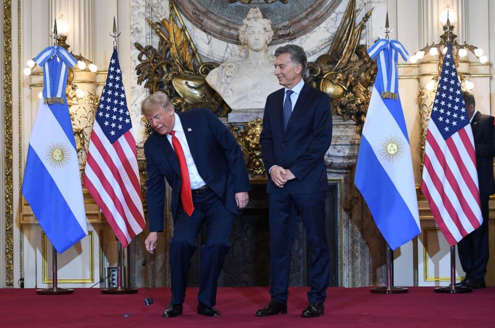 PHOTO: President Donald Trump puts down the translation device during his welcome by Argentina's President Mauricio Macri, right, at Casa Rosada presidential house in Buenos Aires, Argentina, Nov. 30, 2018, on the sidelines of the G20 Leaders' Summit.