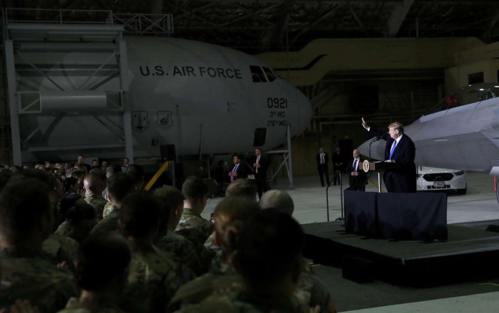 PHOTO: President Donald Trump waves as he speaks to members of the U.S. military after his summit meeting with North Korea's Kim Jong Un in Vietnam during a refueling stop at Elmendorf Air Force Base in Anchorage, Alaska, Feb. 28, 2019.