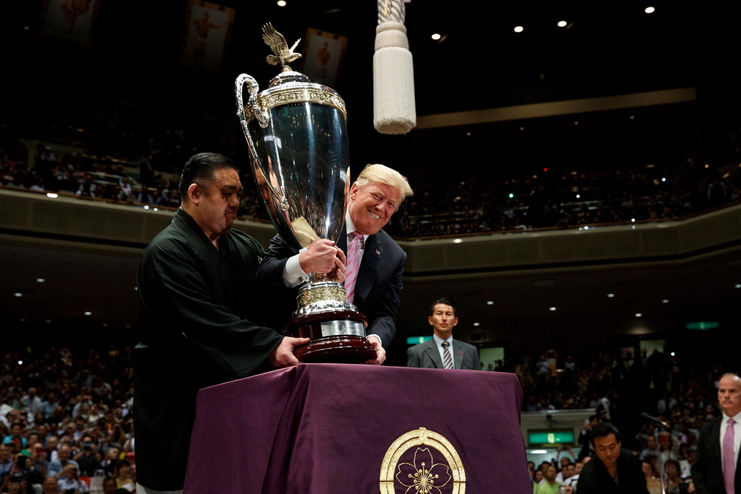 PHOTO: President Donald Trump picks up the "President's Cup" to present it to the Tokyo Grand Sumo Tournament winner Asanoyama, at Ryogoku Kokugikan Stadium, Sunday, May 26, 2019, in Tokyo.