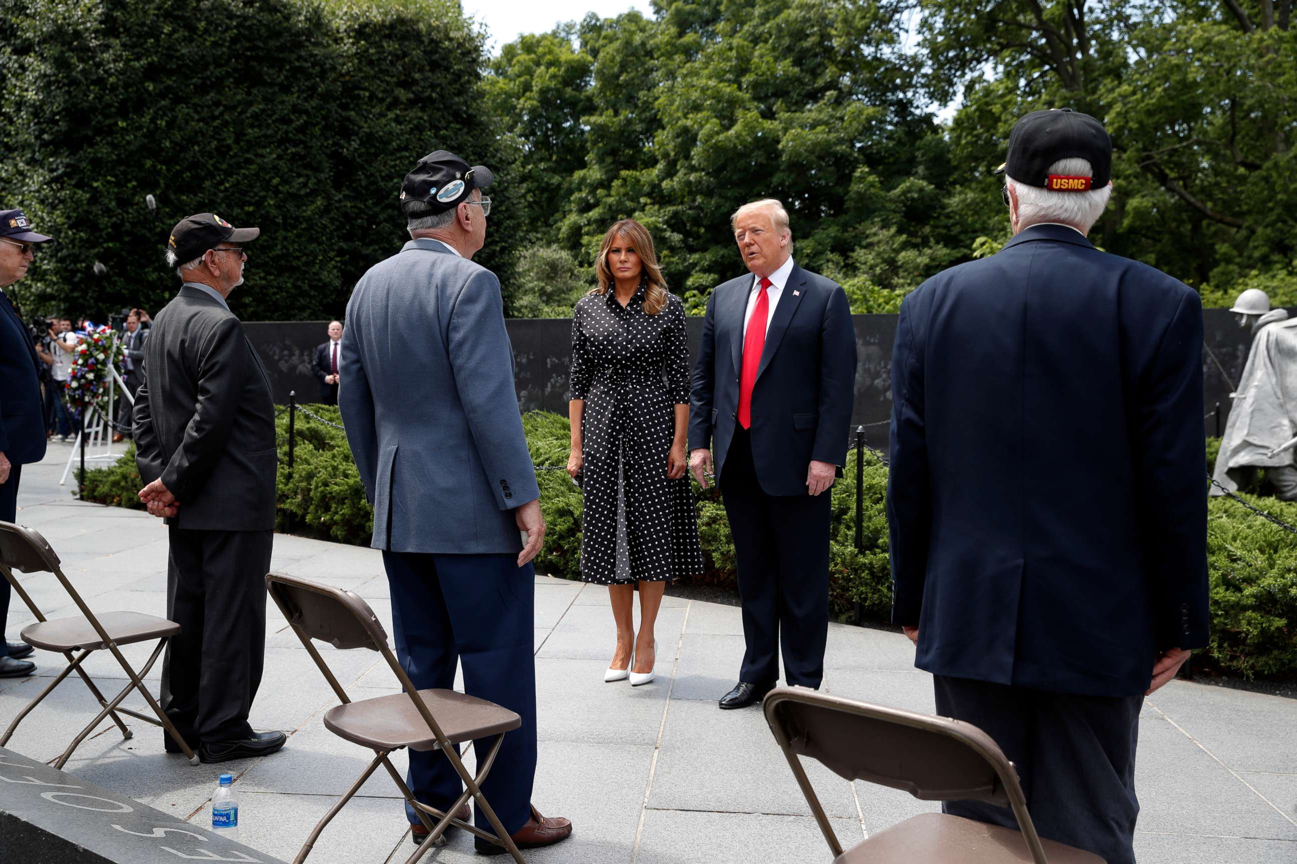 PHOTO: President Donald Trump, accompanied by first lady Melania Trump, speaks with veterans after a wreath placing ceremony at the Korean War Veterans Memorial, Thursday, June 25, 2020, in Washington.