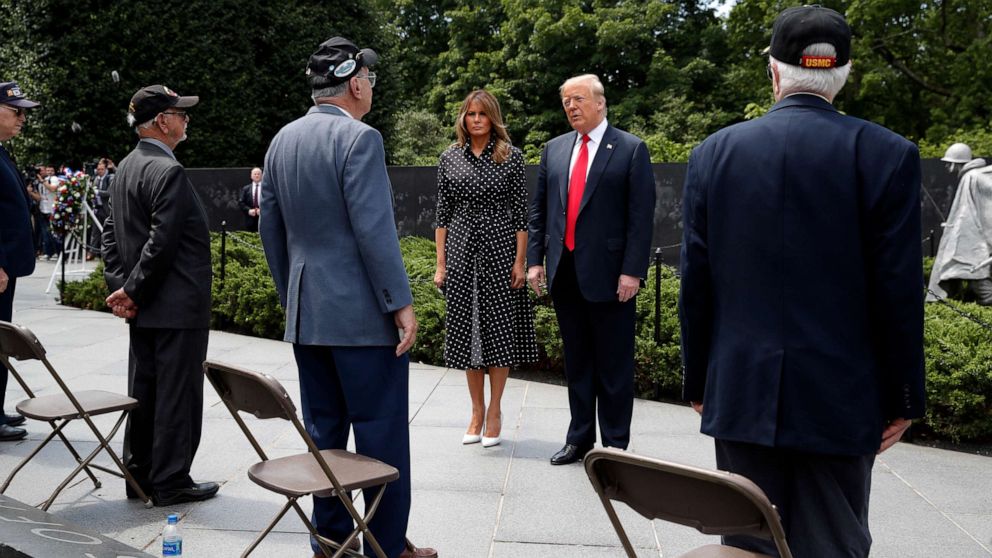 PHOTO: President Donald Trump, accompanied by first lady Melania Trump, speaks with veterans after a wreath placing ceremony at the Korean War Veterans Memorial, Thursday, June 25, 2020, in Washington.