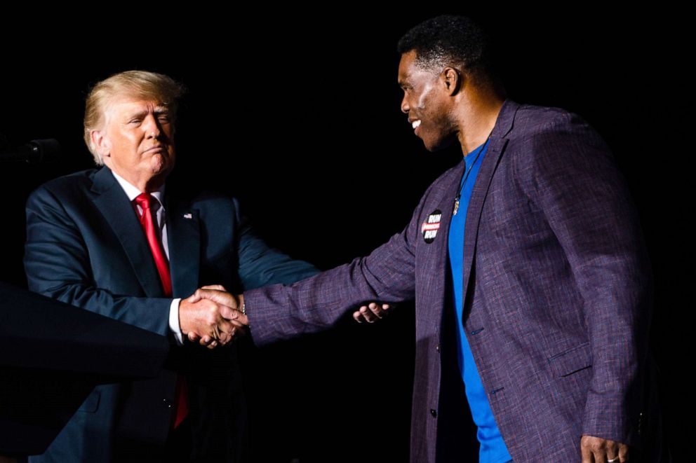 PHOTO: Former President Donald J. Trump shake hands with politician Herschel Walker at his Save America rally at the Georgia National Fairgrounds in Perry, Georgia on September 25, 2021.