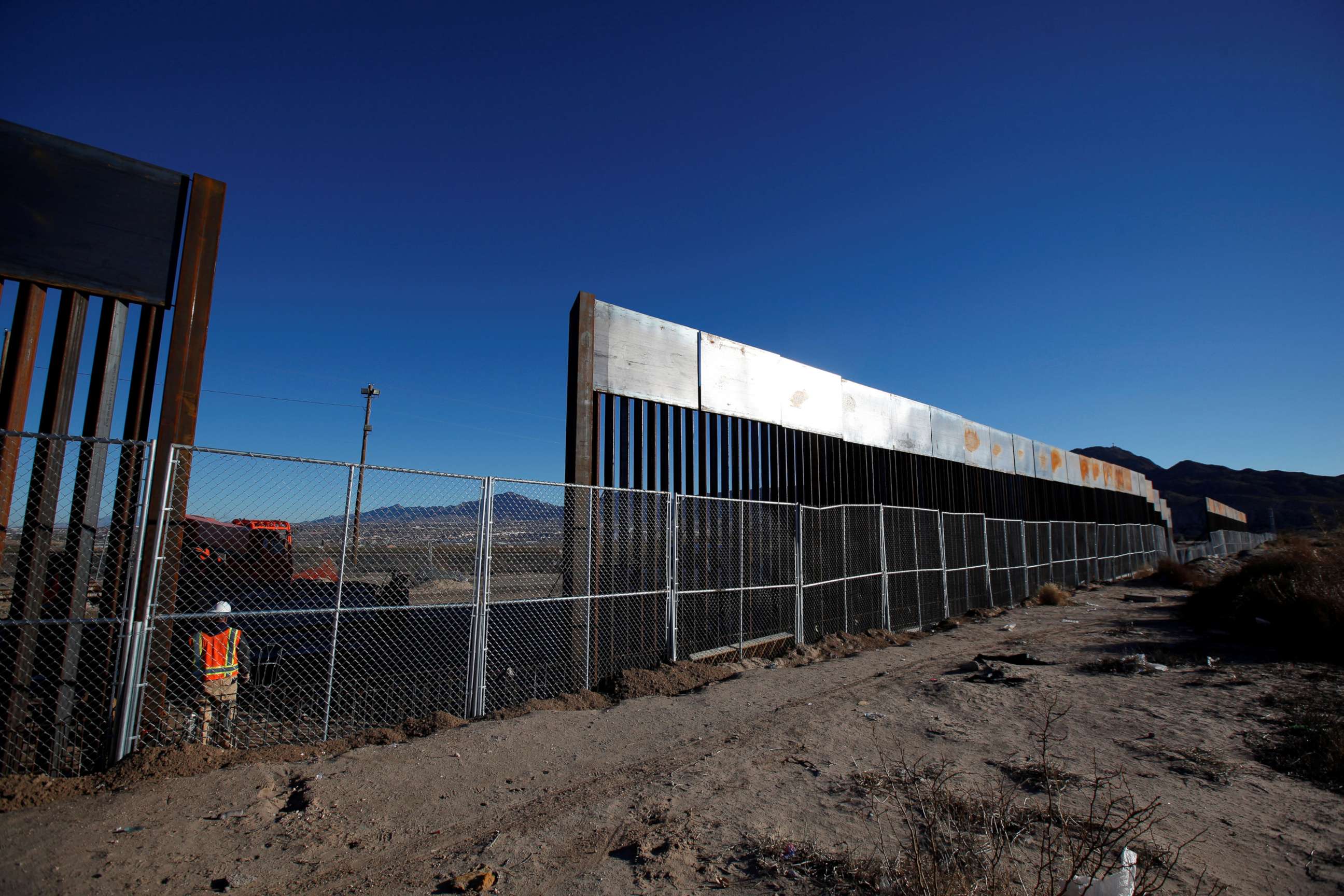 PHOTO: A worker stands next to a newly built section of the U.S.-Mexico border fence at Sunland Park, U.S. opposite the Mexican border city of Ciudad Juarez, Mexico, Jan. 25, 2017.