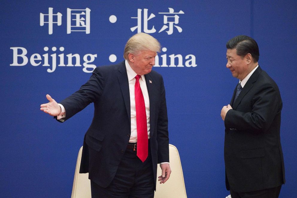 PHOTO: President Donald Trump gestures next to China's President Xi Jinping during a business leaders event at the Great Hall of the People in Beijing, Nov. 9, 2017.