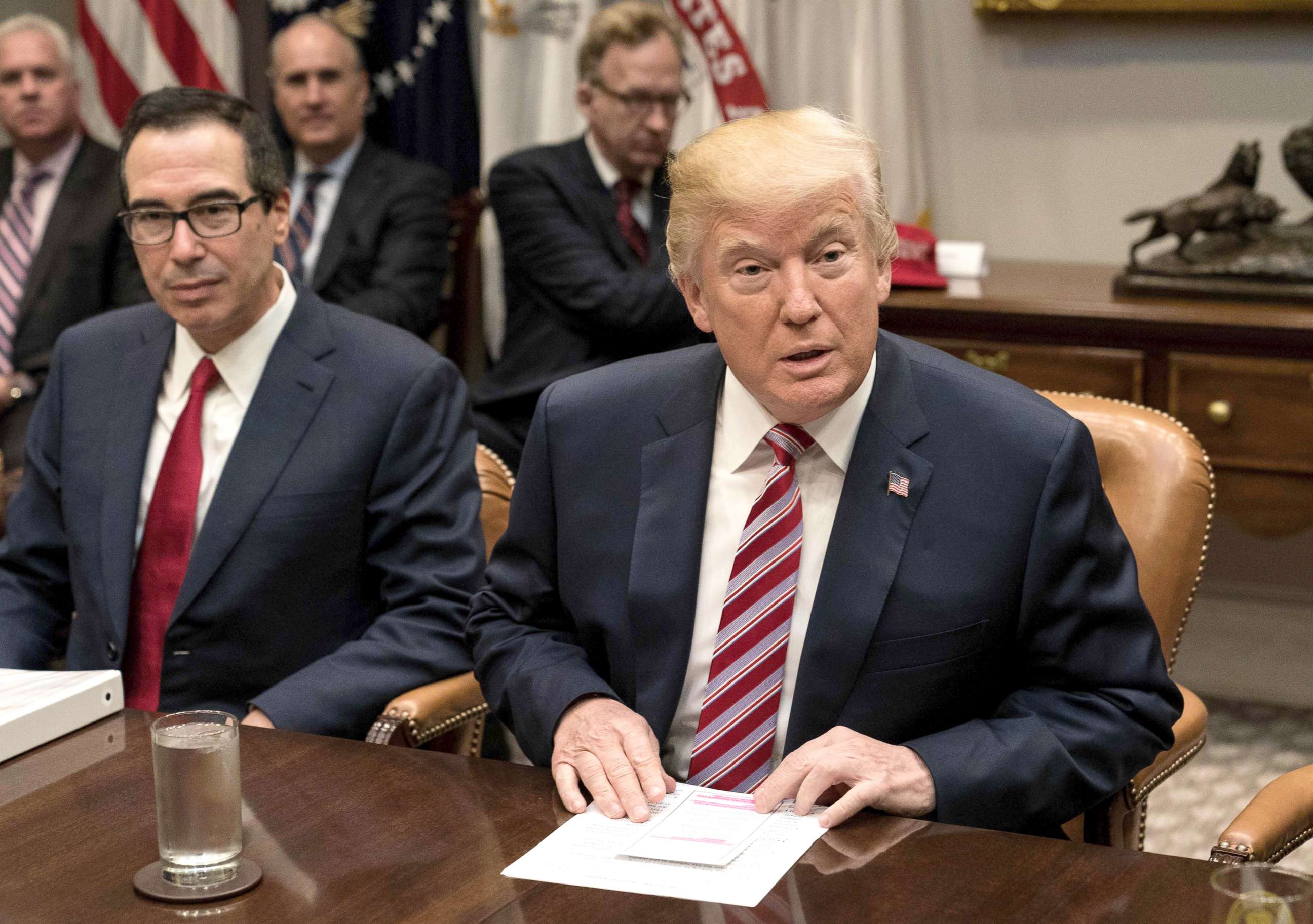 PHOTO: Treasury Secretary Steve Mnuchin, left, sitting next to President Donald Trump as he speaks at a meeting with business leaders on tax reform at the White House, Oct. 31, 2017. 