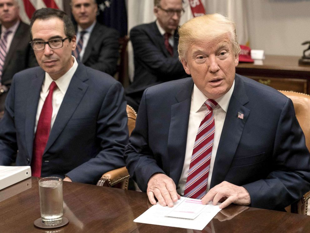 PHOTO: Treasury Secretary Steve Mnuchin, left, sitting next to President Donald Trump as he speaks at a meeting with business leaders on tax reform at the White House, Oct. 31, 2017.