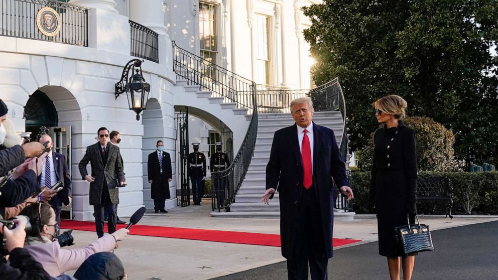 PHOTO: President Donald Trump and first lady Melania Trump stop to talk with the media as they walk to board Marine One on the South Lawn of the White House, Jan. 20, 2021, in Washington, D.C.
