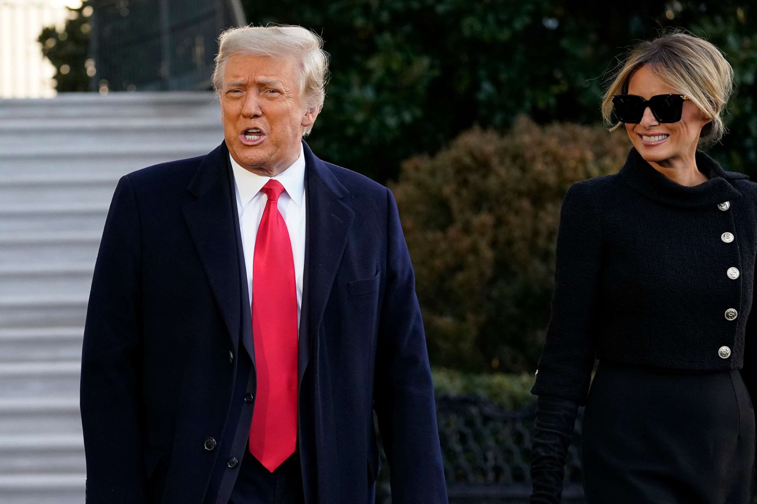 PHOTO: President Donald Trump and first lady Melania Trump stop to talk with the media as they walk to board Marine One on the South Lawn of the White House,Jan. 20, 2021, in Washington.