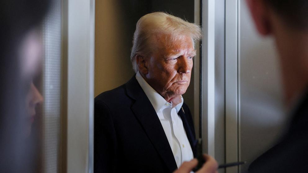 PHOTO: President Donald Trump looks on as reporters ask questions aboard Air Force One during a flight from Las Vegas to Miami, Jan. 25, 2025.