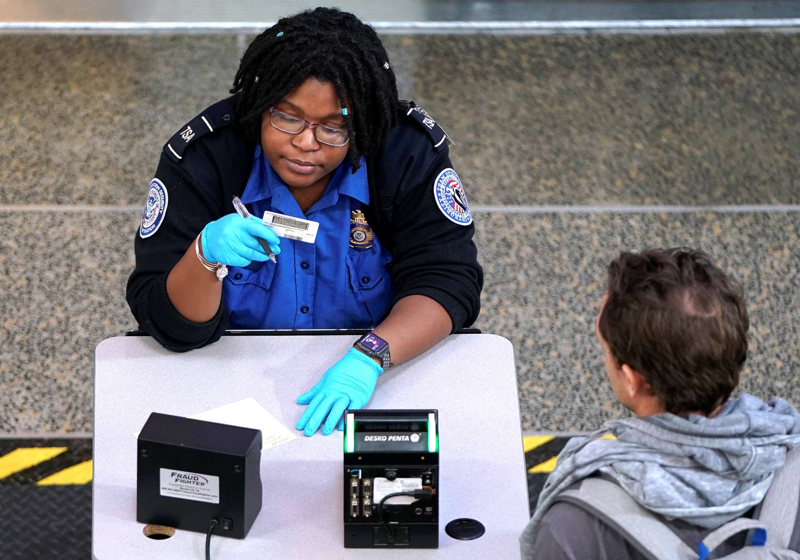 PHOTO: An employee with the Transportation Security Administration checks the documents of a traveler at Reagan National Airport in Washington D.C., Jan. 6, 2019.   